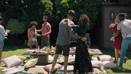 happy friends arriving at garden party celebration hugging enjoying friendship reunion gathering sitting at table with healthy food sharing weekend picnic together 4k