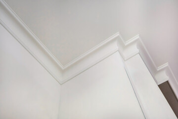 corner of ceiling and walls with intricate crown moulding. Interior construction and renovation...