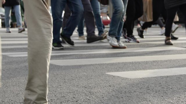Busy people crowd are crossing the street