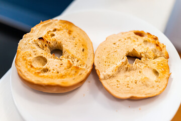 Bagel bread toasted slices closeup on white plate as breakfast food with plain no toppings