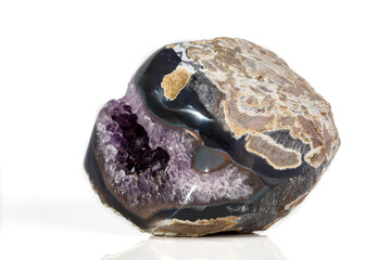 Macro Mineral Stone Amethysts in the rock on a white background