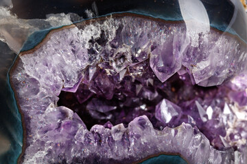 Macro Mineral Stone Amethysts in the rock on a white background