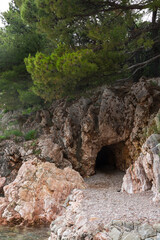 Cave in the Milocher park with a view to the King's Beach in Sveti Stefan