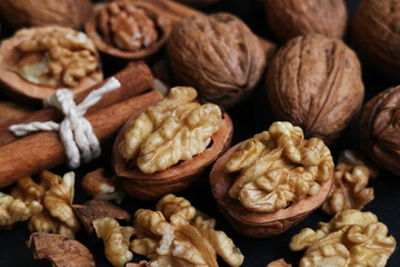 Close up of walnut kernels texture with shell in background. Walnuts provide healthy fats, fiber, vitamins and minerals. It's an exceptionally nutritious nut. With higher antioxidant activity