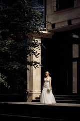 Beautiful caucasian bride on a dark background near the house