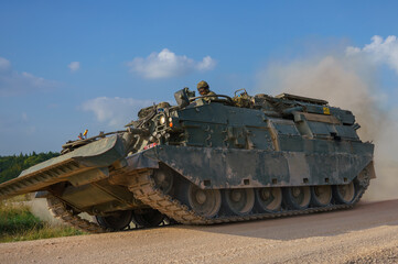 close up of a British Army Challenger Armored Repair and Recovery Vehicle (CRARRV) in action on a...