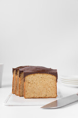 Slices of a vanilla loaf cake with a chocolate coating