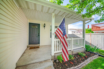Facade of an entrance of a house house with USA flag at the front