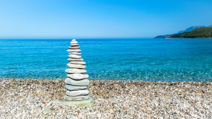 Sea pebble turret for good luck on beach.