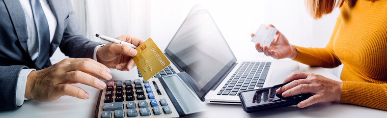 male hands holding a credit card and use mobile phone for Online payment online shopping