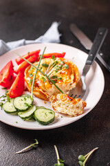 omelet with vegetables fresh breakfast fried eggs and tomato, cucumber fresh portion ready to eat meal snack on the table copy space food background rustic keto or paleo diet veggie 