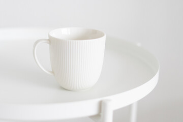 Fototapeta na wymiar white mug on a white table, minimalism