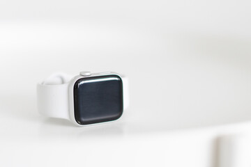smart watch with white strap on white table