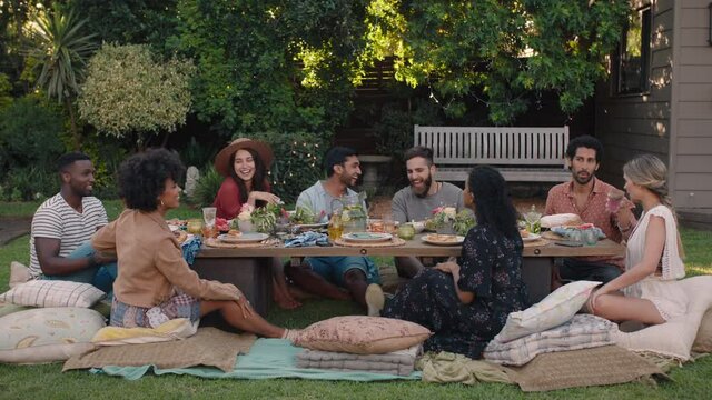 garden party friends celebrating picnic lunch having fun chatting sharing healthy food enjoying weekend reunion relaxing on beautiful summer day outdoors 4k