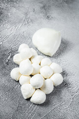 Mozzarella cheese mini balls on kitchen table. White background. Top view