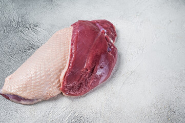 Raw uncooked Duck breast  fillet steaks on butcher table. White background. Top View. Copy space