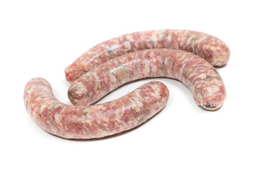 Three crude sausages with mushrooms on a white background