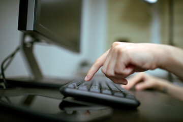 Female hands or woman office worker typing on the keyboard