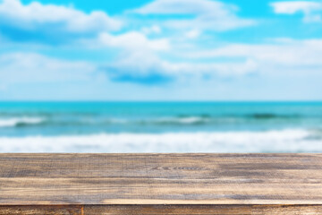 Fototapeta na wymiar wood table top on blur sea wave background