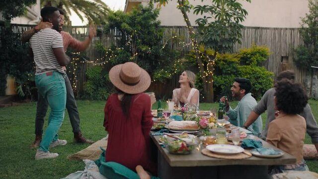 happy friends hugging celebrating reunion enjoying dinner party having fun evening together relaxing on weekend at home in backyard 4k footage