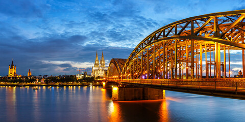 Cologne Cathedral city skyline and Hohenzollern bridge with Rhine river in Germany at twilight panoramic view