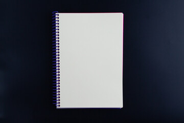 Notebook with white pages on black background