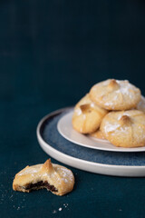 Chocolate filled shortbread cookies on a dark background