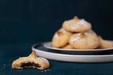Chocolate filled shortbread cookies on a dark background