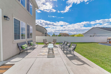 Large outdoor patio with chairs and table on the rug