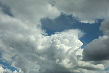 Naklejka na ściany i meble Clouds in the sky. White air masses in the blue sky.