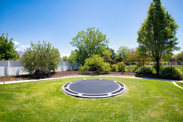 In-ground trampoline on a lawn at the backyard in Utah