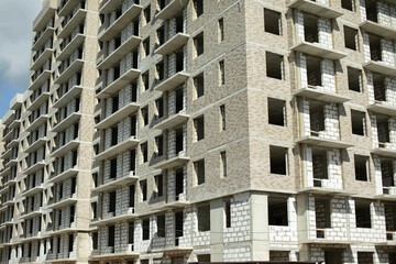 Construction of the building. Unfinished house. Concrete structure.