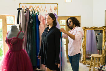 Male fashion designer with a client