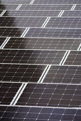 LED panel switched off between solar panels with snow.