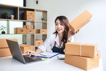 businesswoman start small business and successful SME entrepreneurs A woman works from home delivering parcels online. SME delivery concept and packaging