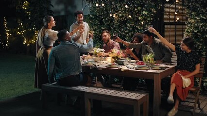 dinner party friends celebrating making toast to friendship at evening dinner celebration drinking wine sharing homemade meal enjoying weekend reunion relaxing on calm summer night outdoors 4k