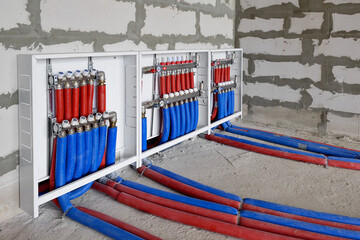 Heating system manifold valves for heat flooring and water supply in a country house. Pipes...
