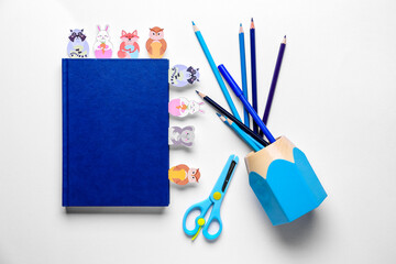 Cute bookmarks with book and stationery on white background