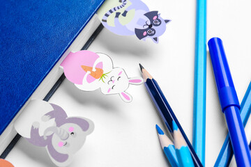 Cute bookmarks with book and stationery on white background