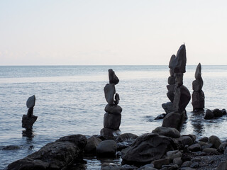 Elongated stone pyramids built on the shores of a calm sea