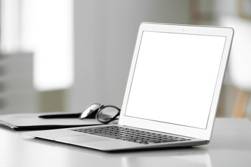 Modern laptop on table in room