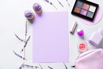 Composition with blank sheet of paper, cosmetics and cupcakes on light background