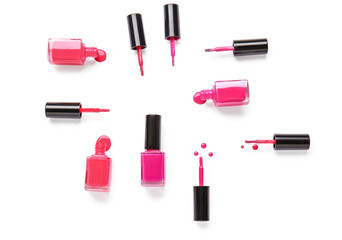 Obraz premium Bottles of nail polishes with brushes and blots on white background