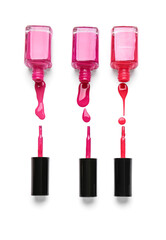 Bottles of nail polishes with brushes and blots on white background
