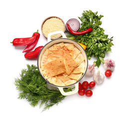 Cooking pot with tasty Shah Pilaf and ingredients on white background