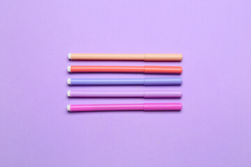 Colorful markers on color background