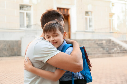 Father Saying Goodbye To His Son Near School