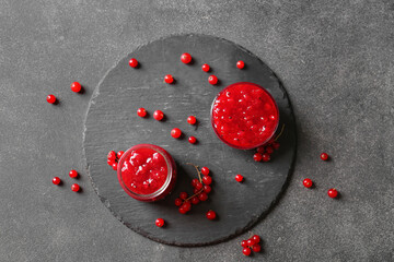 Composition with red currant jam on dark background
