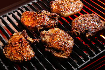 Tasty pork steaks on barbecue grill