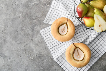 Tasty pear pot pies and fresh fruits on grunge background
